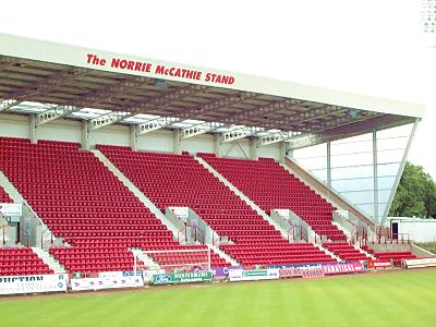 (c) www.DAFC.net
Photographs can be requested from photos@dafc.net
The Norrie McCathie Stand, named after the inspirational Pars captain who tragically died on 8th January 1996. Home fans occupy this, the town end of the ground. Changing rooms are located under this stand and the players emerge from a tunnel in the bottom left hand corner.
(NorrieMcCathie.jpg)
